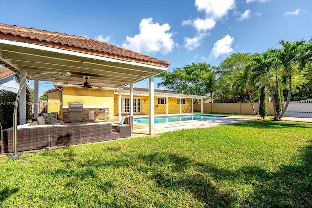 back of property featuring a patio, area for grilling, a fenced in pool, a lawn, and ceiling fan