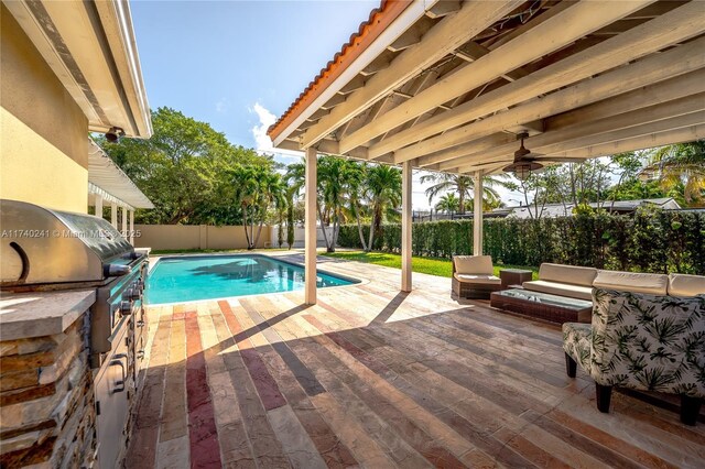 view of swimming pool with area for grilling and a grill