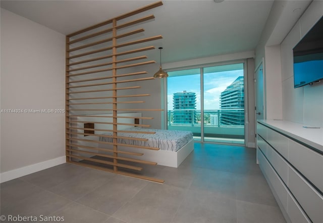 unfurnished bedroom with tile patterned flooring and access to outside