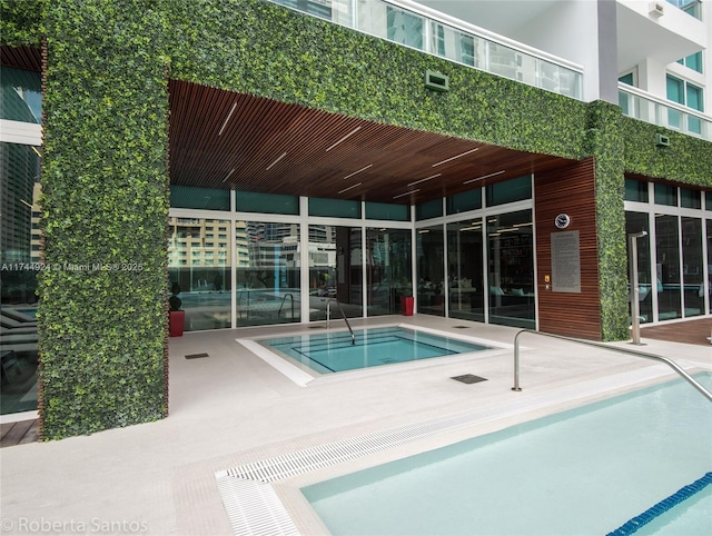 view of pool featuring a patio area and a hot tub