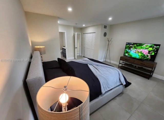 bedroom with light tile patterned floors