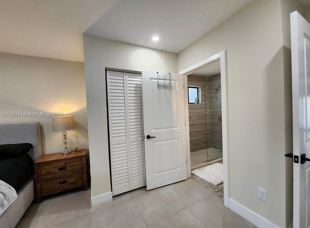 tiled bedroom with a closet