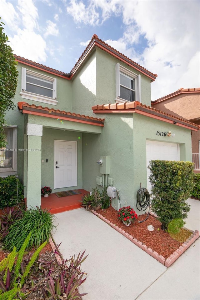 mediterranean / spanish-style house with a garage