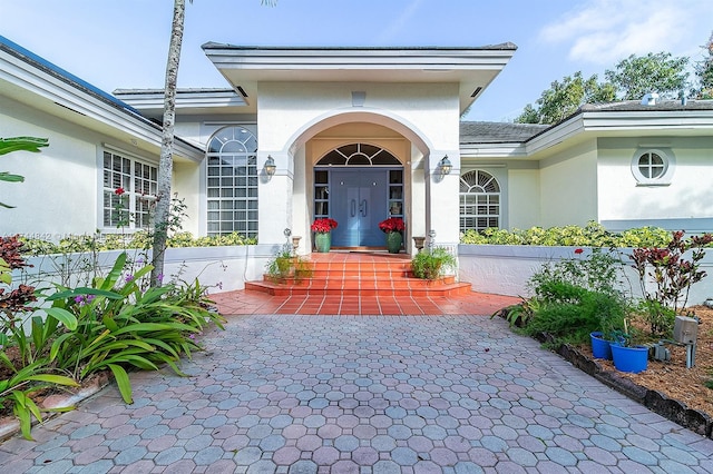 entrance to property featuring stucco siding