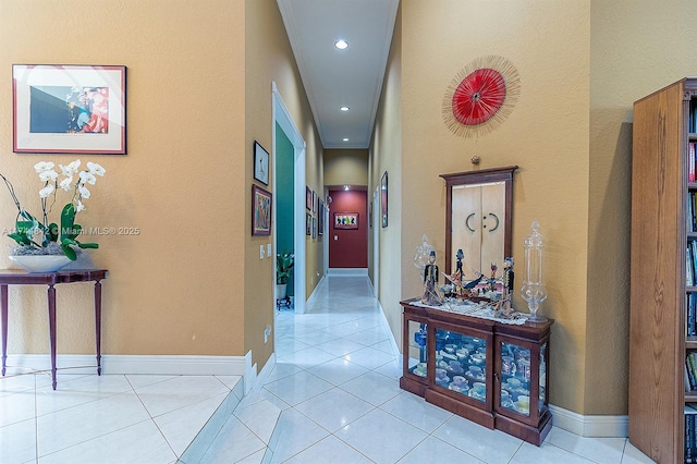 hallway featuring recessed lighting, baseboards, and tile patterned flooring