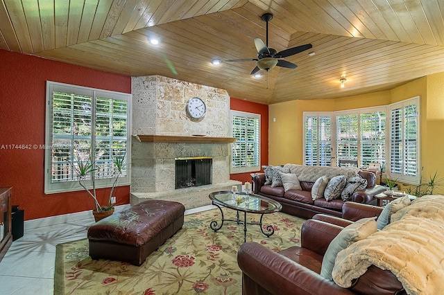 living area with tile patterned floors, lofted ceiling, wooden ceiling, and a fireplace