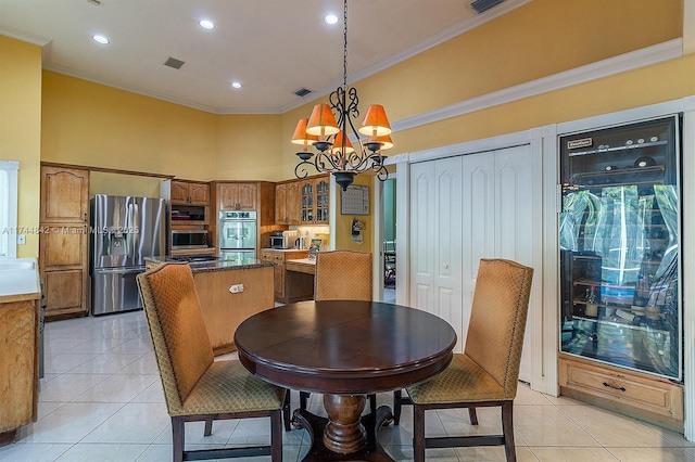 dining room featuring an inviting chandelier, light tile patterned flooring, and ornamental molding