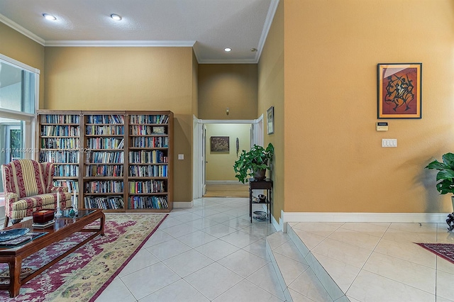 living area featuring crown molding, light tile patterned floors, and baseboards