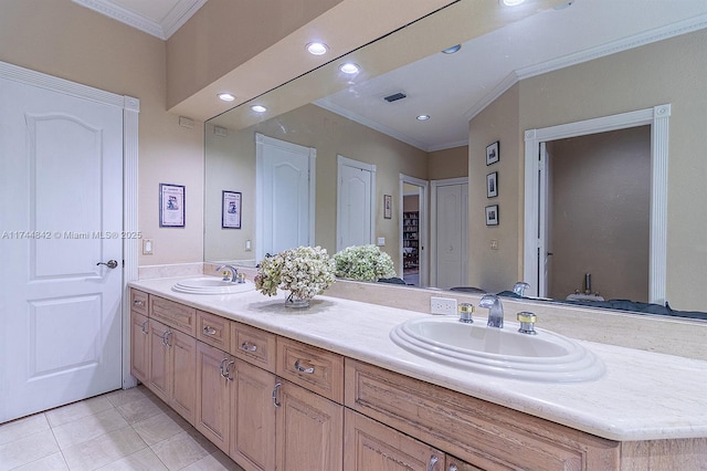 bathroom with double vanity, visible vents, ornamental molding, and a sink