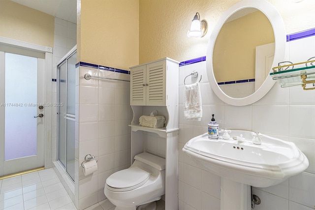 full bath featuring tile walls, toilet, and a stall shower