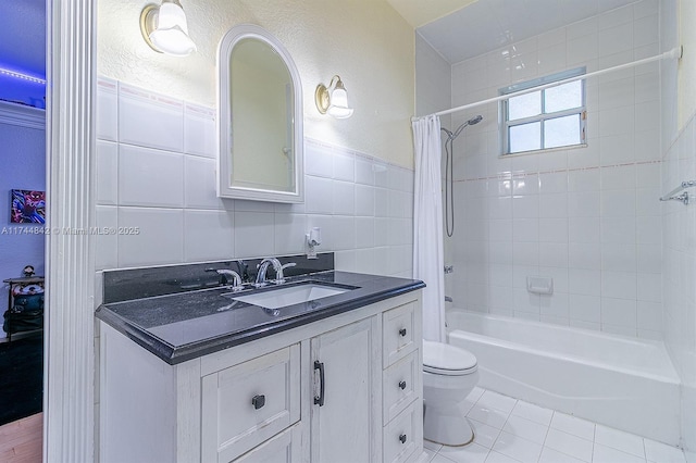 bathroom featuring tile patterned flooring, toilet, vanity, tile walls, and shower / bathtub combination with curtain