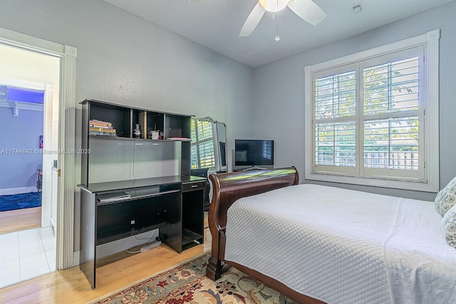 bedroom with wood finished floors and a ceiling fan