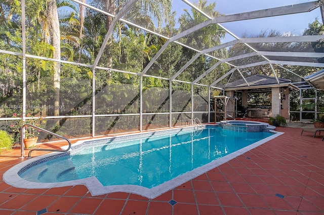 view of pool with glass enclosure, a patio, and a pool with connected hot tub