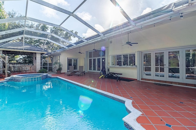 view of pool with a pool with connected hot tub, glass enclosure, french doors, a ceiling fan, and a patio