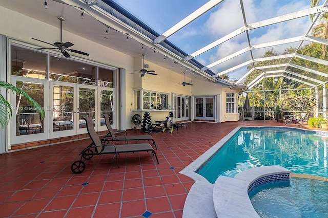 view of pool featuring french doors, a lanai, a ceiling fan, and a patio area