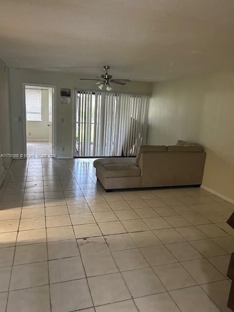 unfurnished living room with light tile patterned floors and ceiling fan