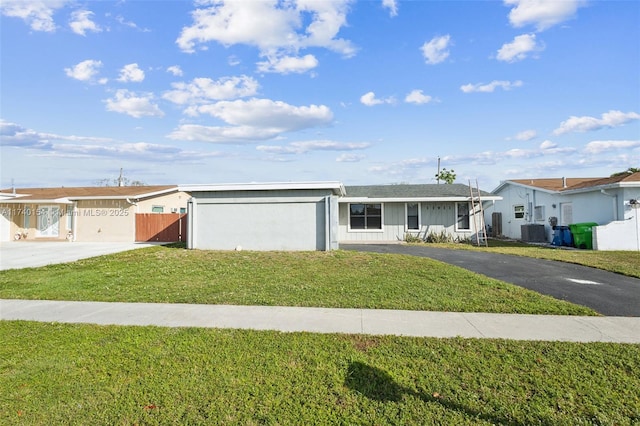 single story home with central AC, a garage, and a front lawn