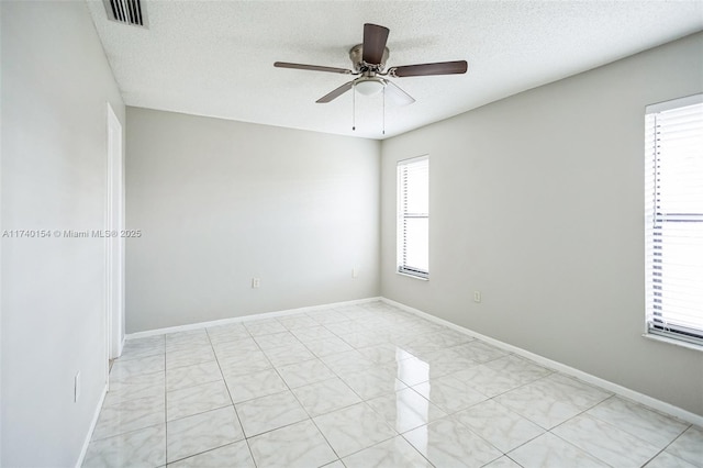 spare room with ceiling fan and a textured ceiling