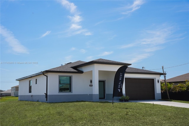 prairie-style house featuring a garage and a front lawn