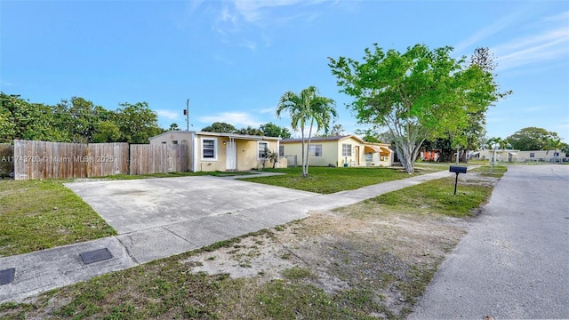 ranch-style home with a front lawn