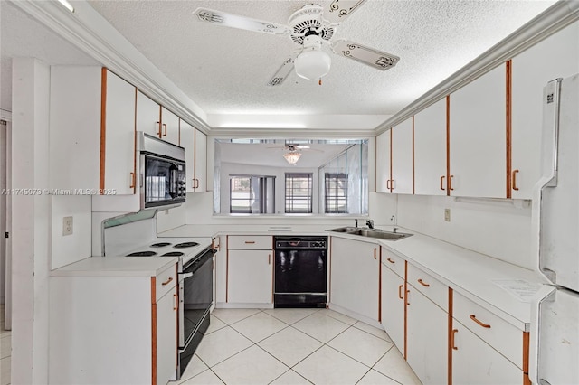 kitchen featuring range with electric cooktop, dishwasher, ceiling fan, freestanding refrigerator, and a sink