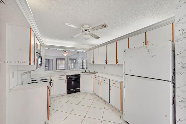 kitchen featuring black dishwasher, ceiling fan, freestanding refrigerator, light countertops, and a sink