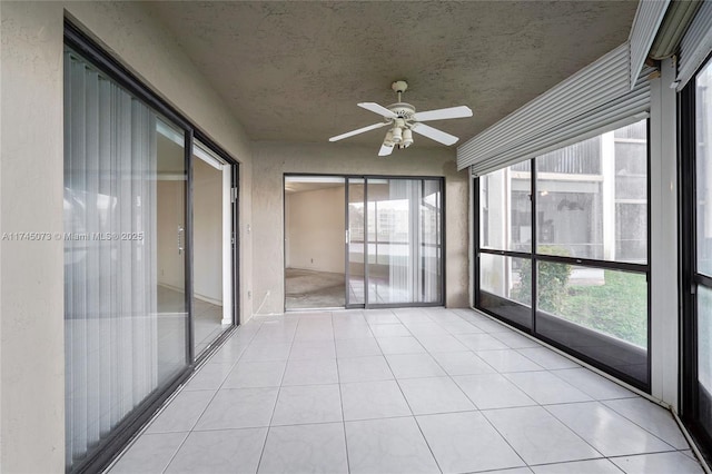 unfurnished sunroom featuring ceiling fan