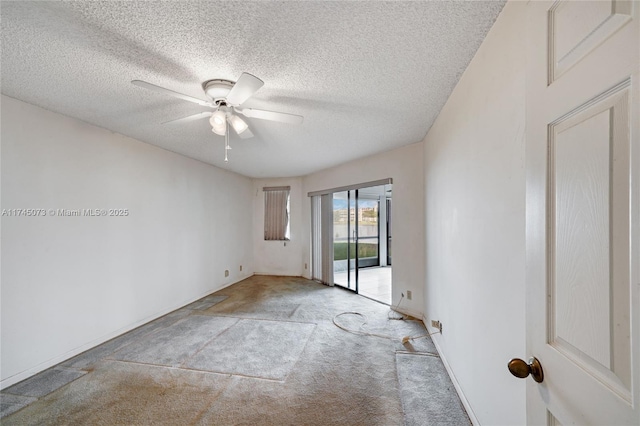 empty room with ceiling fan, a textured ceiling, baseboards, and carpet flooring