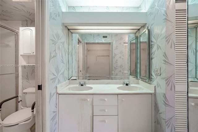 full bathroom featuring a closet, a sink, toilet, and wallpapered walls