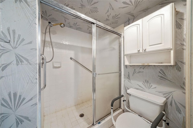 full bath with a stall shower and toilet