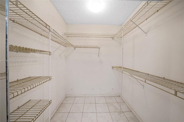 walk in closet featuring light tile patterned floors