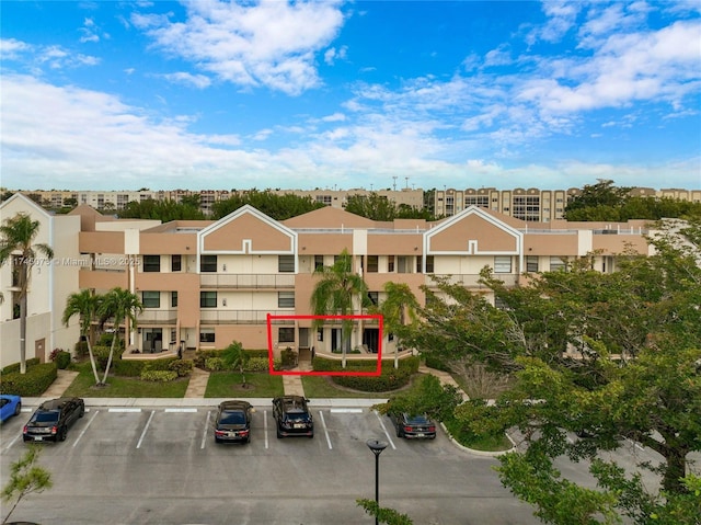 view of property featuring uncovered parking and a residential view