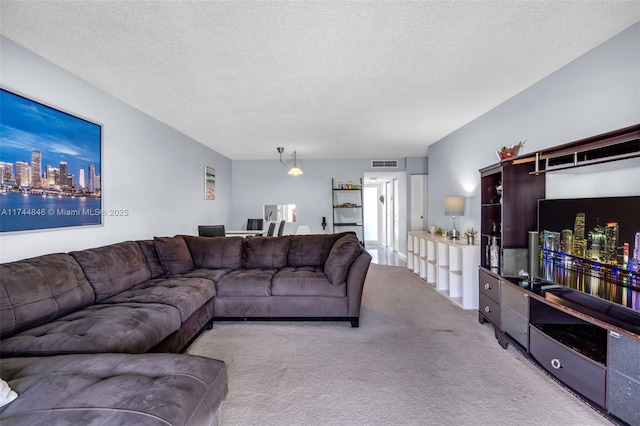 living room featuring light colored carpet and a textured ceiling