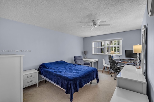 carpeted bedroom with ceiling fan and a textured ceiling