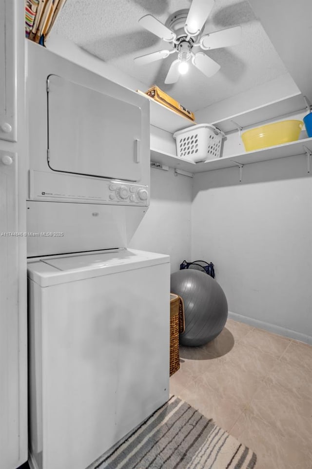 clothes washing area with stacked washer and dryer