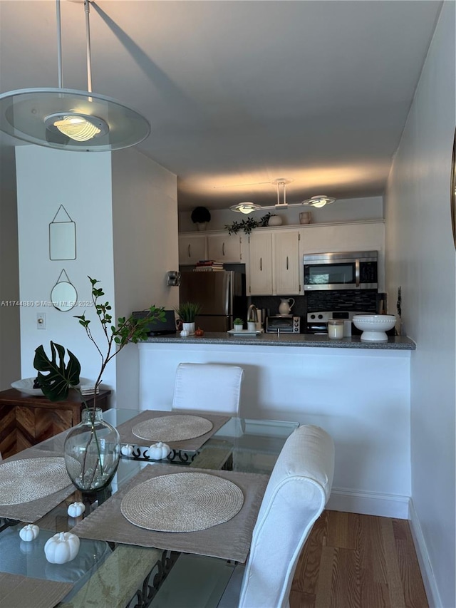 dining area with wood-type flooring