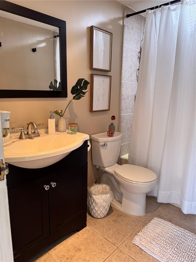 bathroom with tile patterned flooring, vanity, walk in shower, and toilet