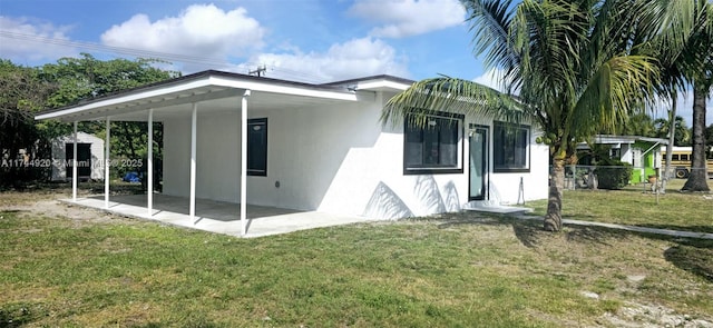 view of home's exterior featuring a patio, a yard, fence, and stucco siding