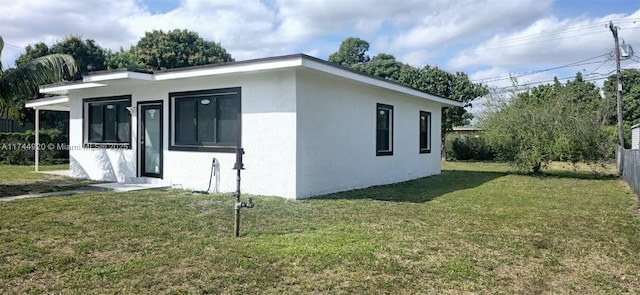 view of property exterior featuring a yard and stucco siding