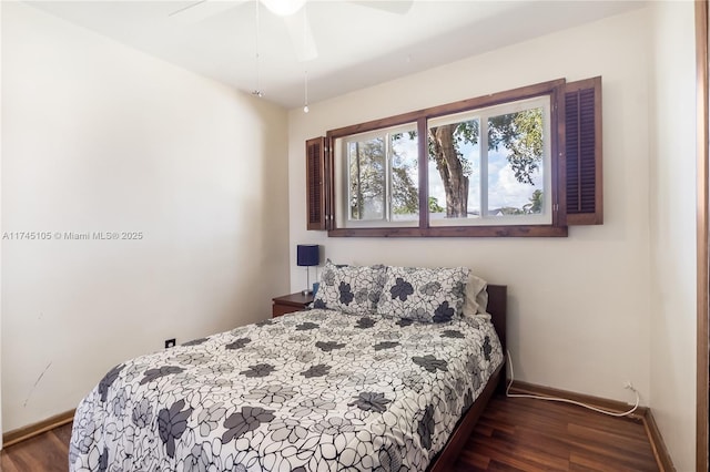 bedroom with dark wood-type flooring and ceiling fan