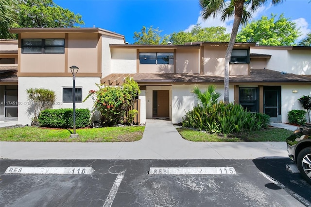 3005 NW 48th Ave Unit 3005, Coconut Creek, FL 33063 - view of front of home with uncovered parking and stucco siding