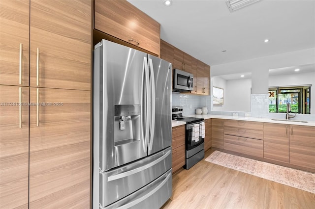 3005 NW 48th Ave Unit 3005, Coconut Creek, FL 33063 - kitchen with stainless steel appliances, a sink, modern cabinets, light countertops, and decorative backsplash