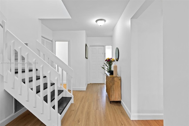 3005 NW 48th Ave Unit 3005, Coconut Creek, FL 33063 - entryway featuring stairs, baseboards, and light wood finished floors