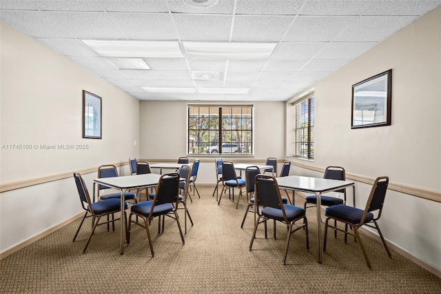 3005 NW 48th Ave Unit 3005, Coconut Creek, FL 33063 - dining room with a drop ceiling, light colored carpet, and baseboards