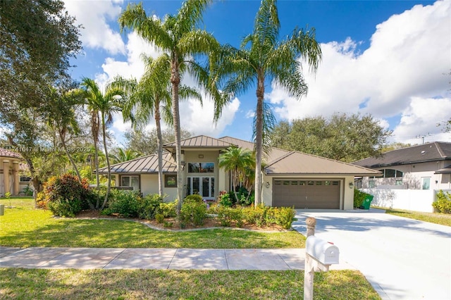 view of front of house with a garage and a front lawn