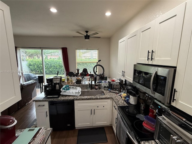 kitchen with dark wood-style floors, range with electric cooktop, white cabinets, dishwasher, and stainless steel microwave