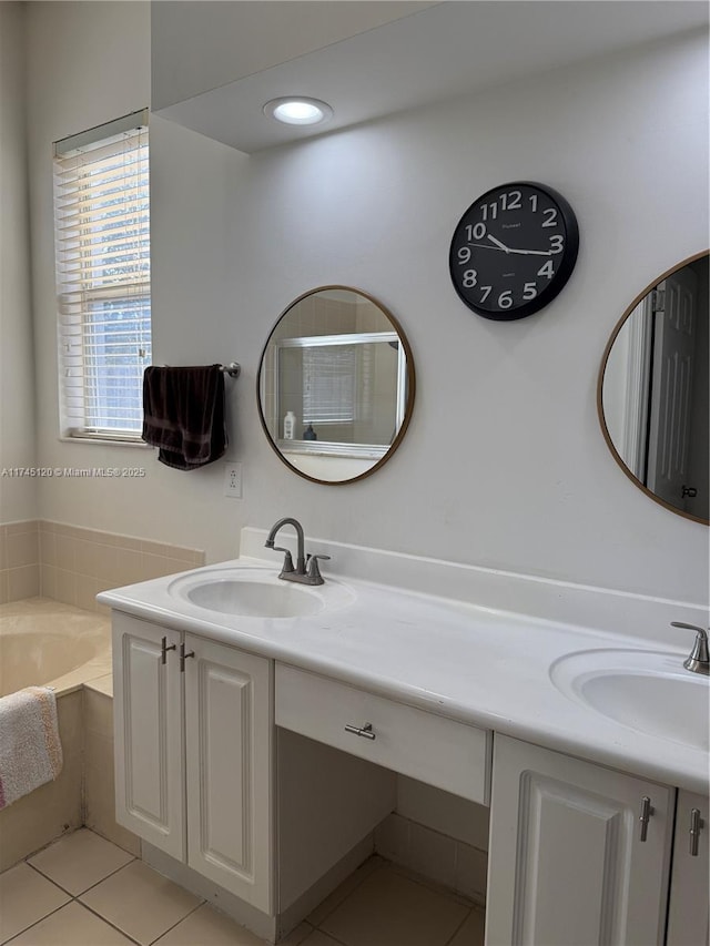 bathroom featuring tile patterned floors, a bath, and vanity