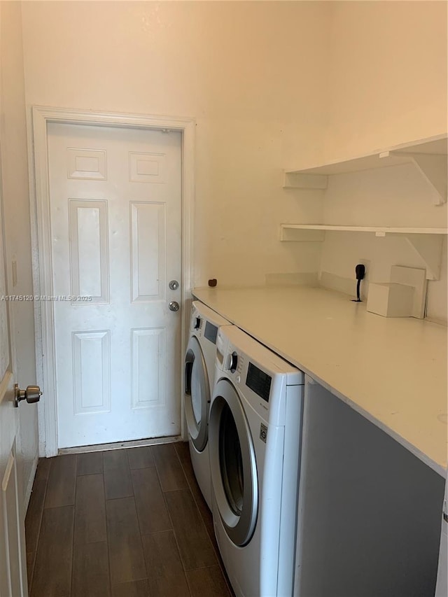 laundry area with wood finish floors, laundry area, and washer and clothes dryer