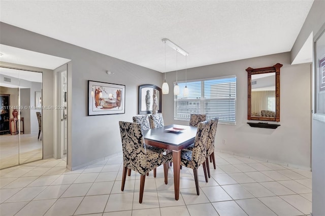 4000 NW 44th Ave Unit 405, Lauderdale Lakes, FL 33319 - dining area with light tile patterned flooring and a textured ceiling