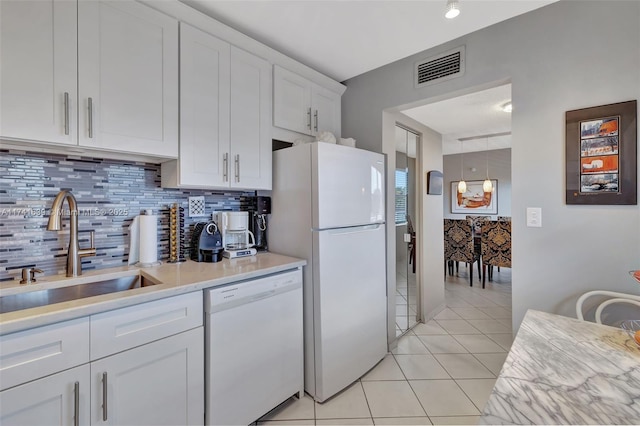 4000 NW 44th Ave Unit 405, Lauderdale Lakes, FL 33319 - kitchen with sink, light tile patterned floors, white appliances, decorative backsplash, and white cabinets